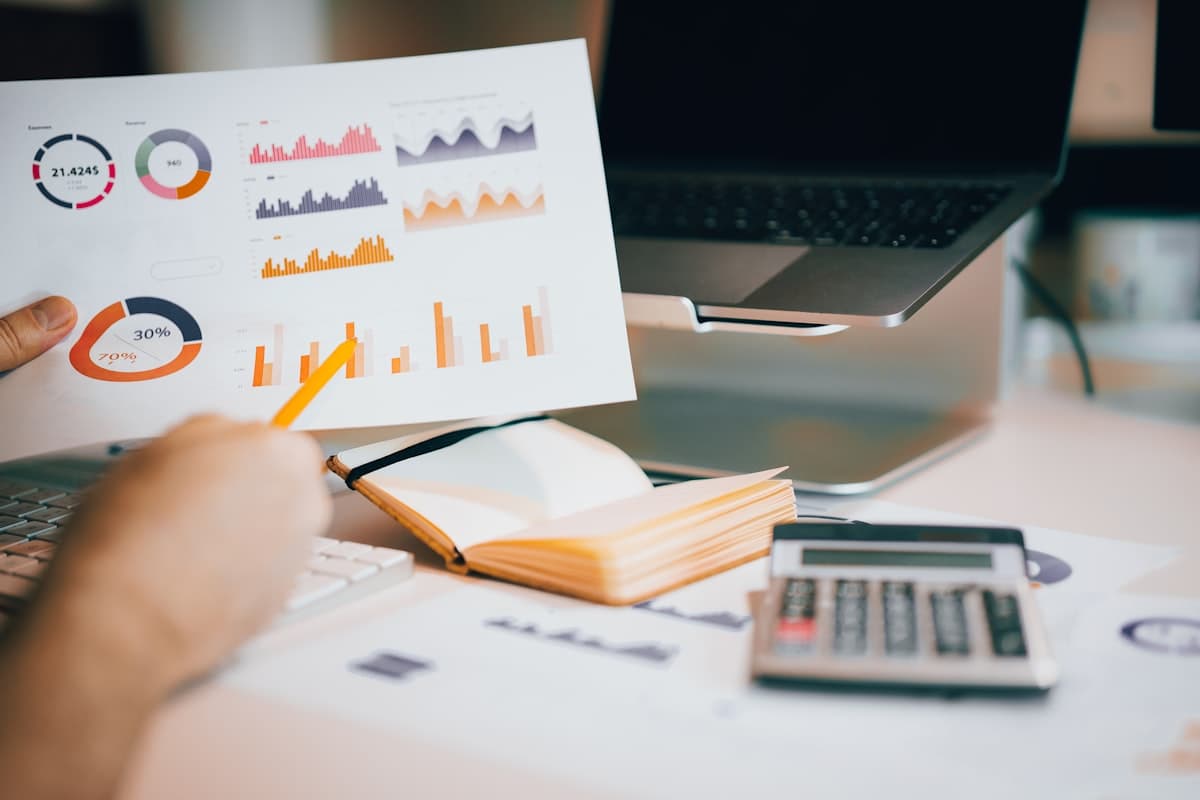Payroll figures on a printed report beside a calculator