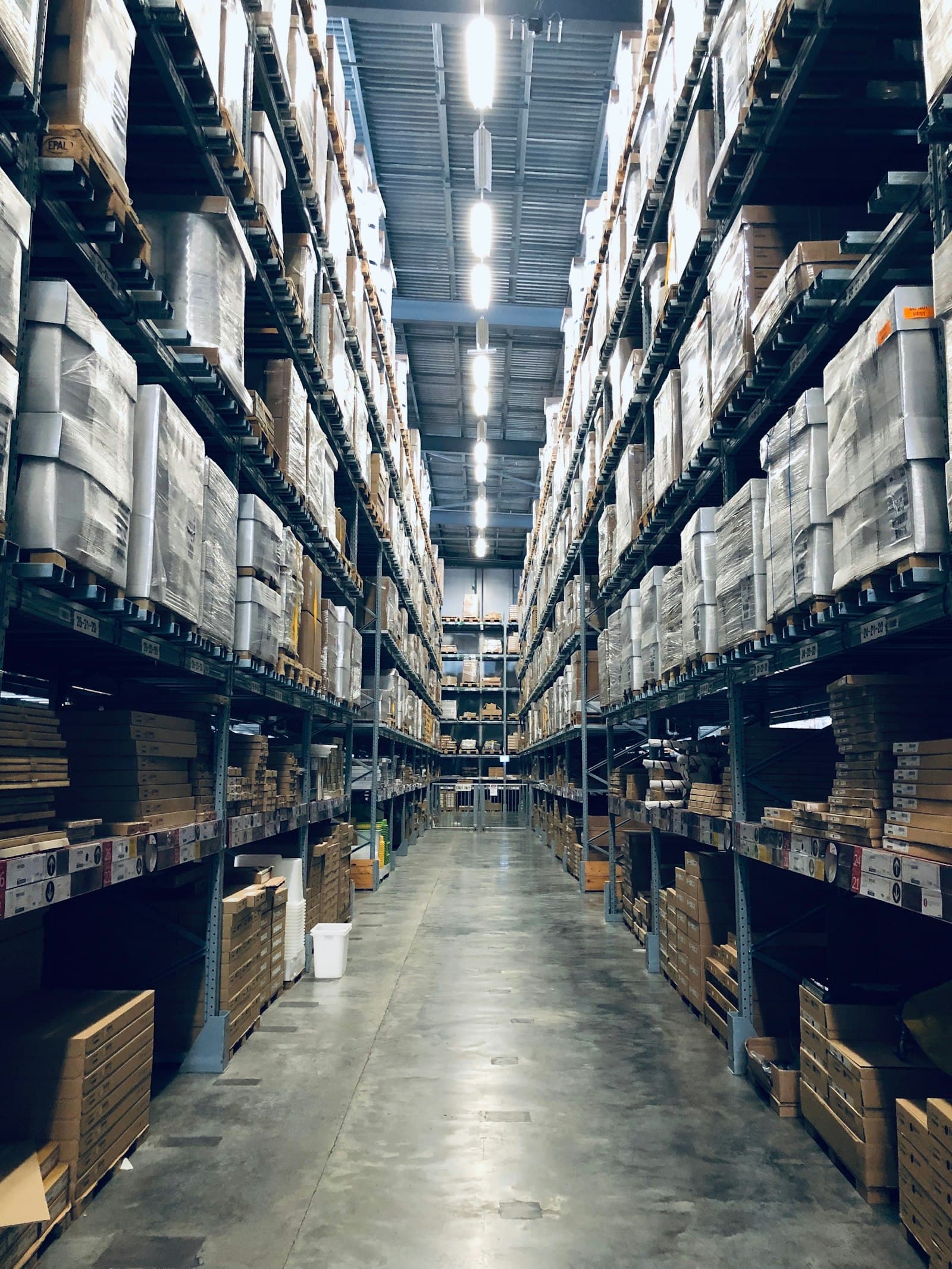 A warehouse aisle stocked floor to ceiling